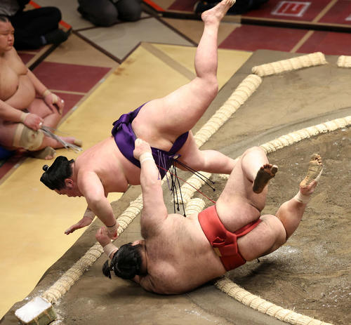 高安（手前）を掛け投げで破る明生（撮影・鈴木正人）