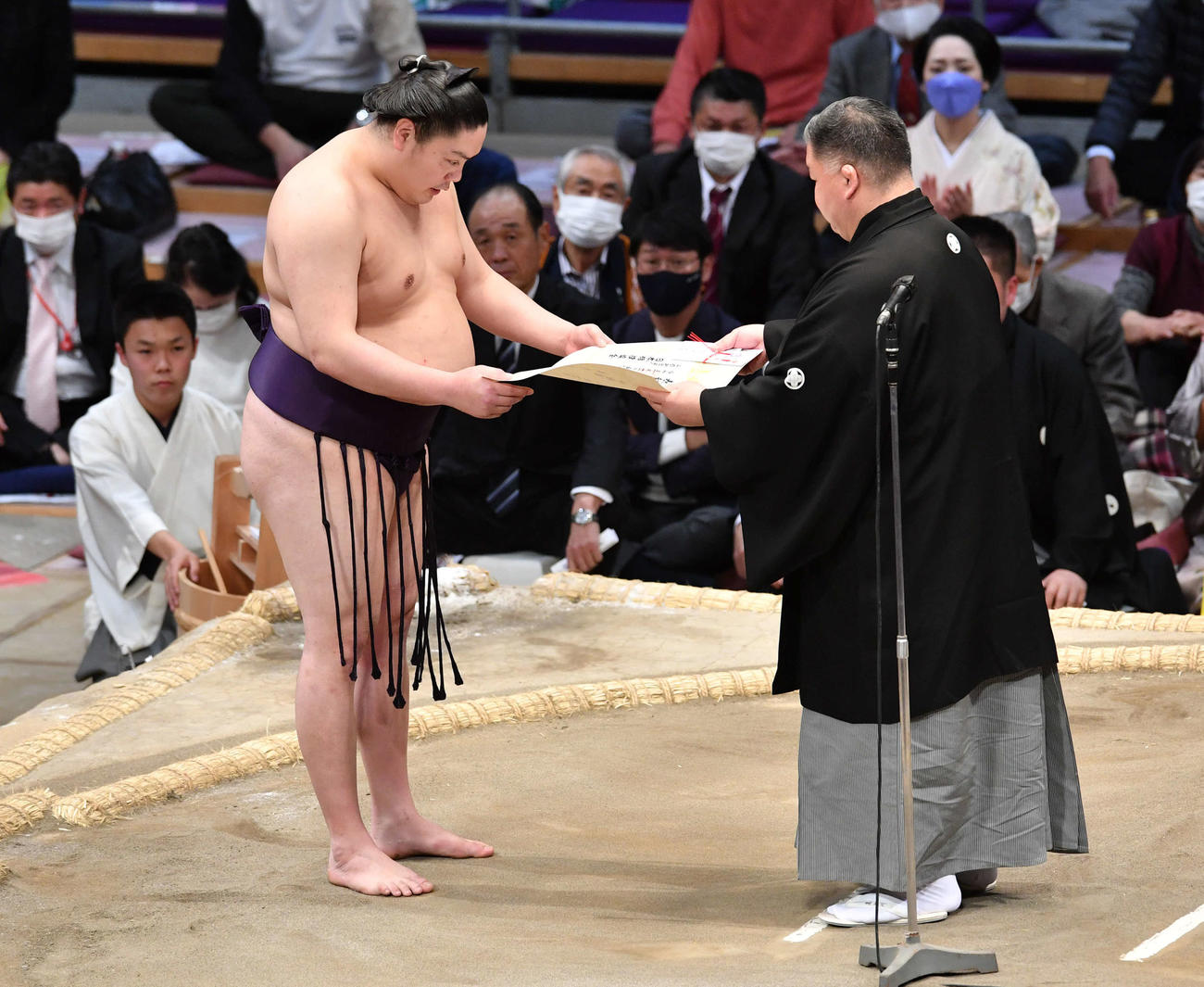 十両優勝の一山本は、高田川審判部副部長（右）から表彰状を受け取る（撮影・岩下翔太）
