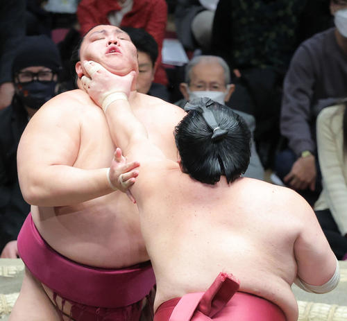 大栄翔（手前）ののど輪に耐える御嶽海（撮影・河田真司）