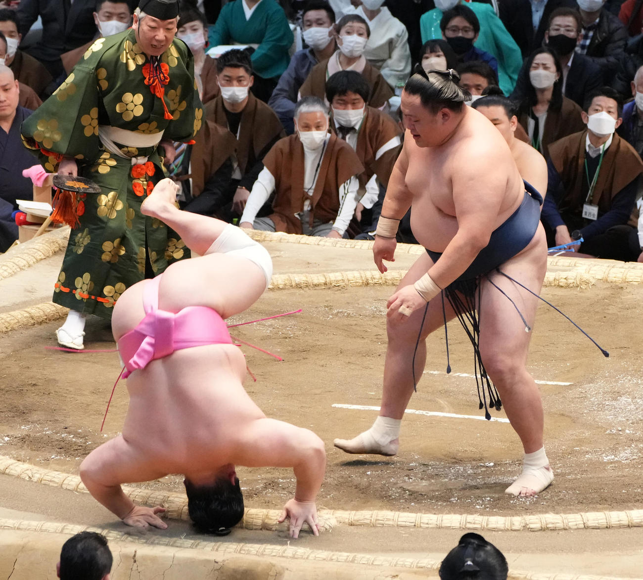 玉鷲（右）に小手投げで敗れた宇良は土俵下へ転げ落ちる（撮影・小沢裕）