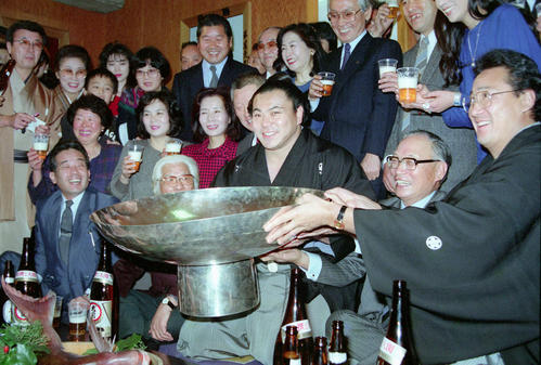 初場所で30度目の優勝を飾った横綱千代の富士（中央）は師匠の九重親方（右端）らと祝う（1990年1月21日撮影）
