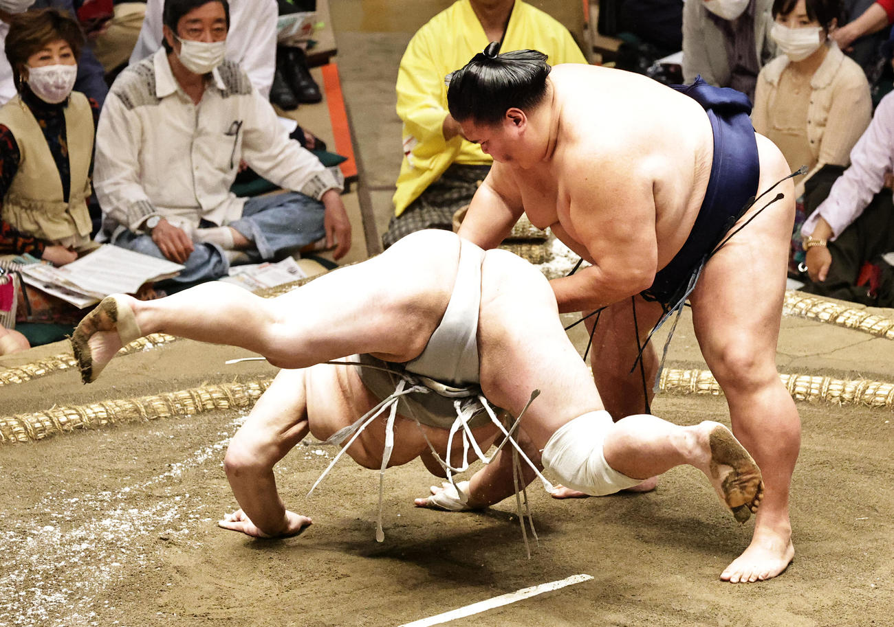 北勝富士（左）を上手出し投げで破る御嶽海（撮影・中島郁夫）