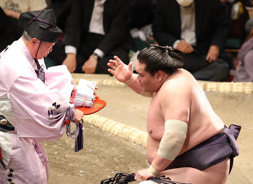 懸賞金の束を受け取る照ノ富士（撮影・鈴木正人）