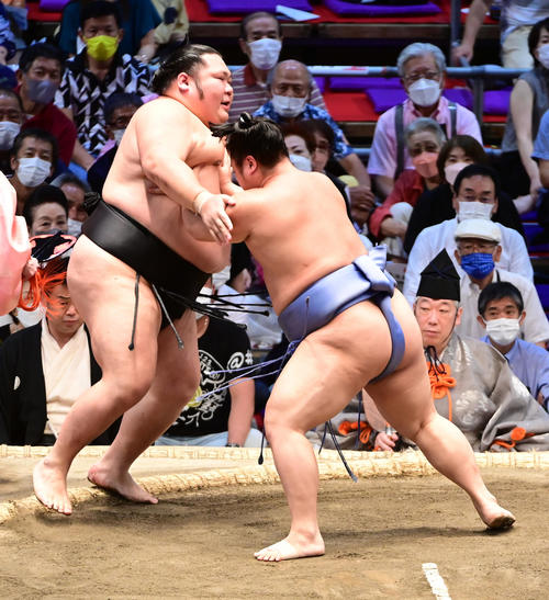 千代大龍（左）を押し出しで破る翔猿（撮影・小沢裕）