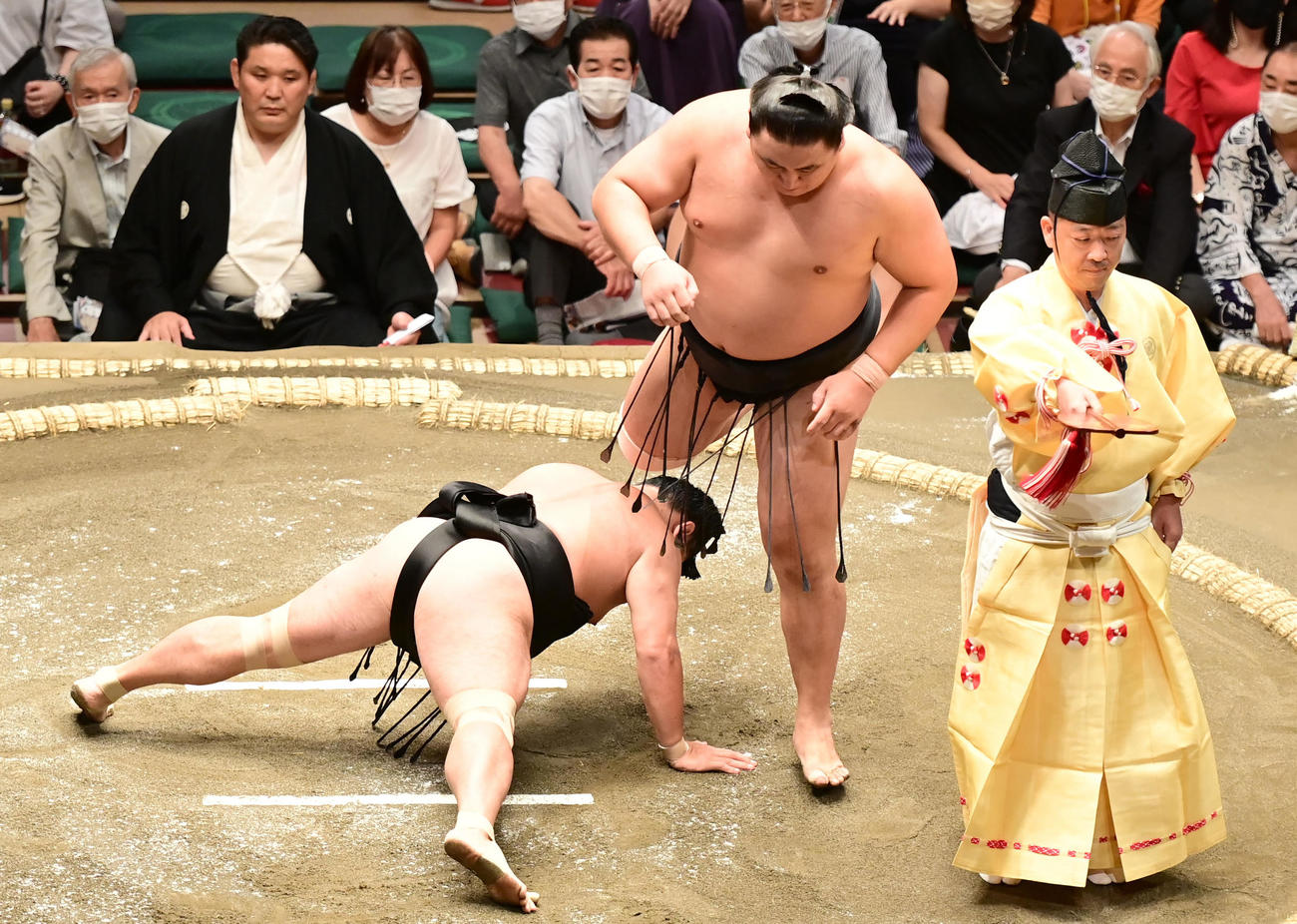 東龍は上手投げで照強（左）を破る（撮影・小沢裕）