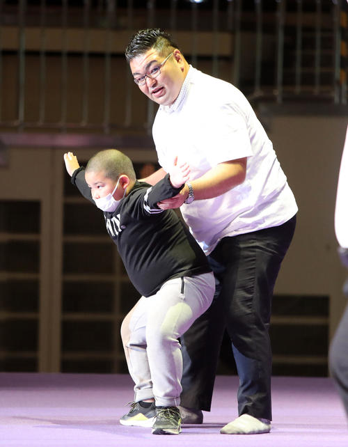 参加者の少年に相撲体操を指導する熊ケ谷親方（元玉飛鳥）（撮影・鈴木正人）