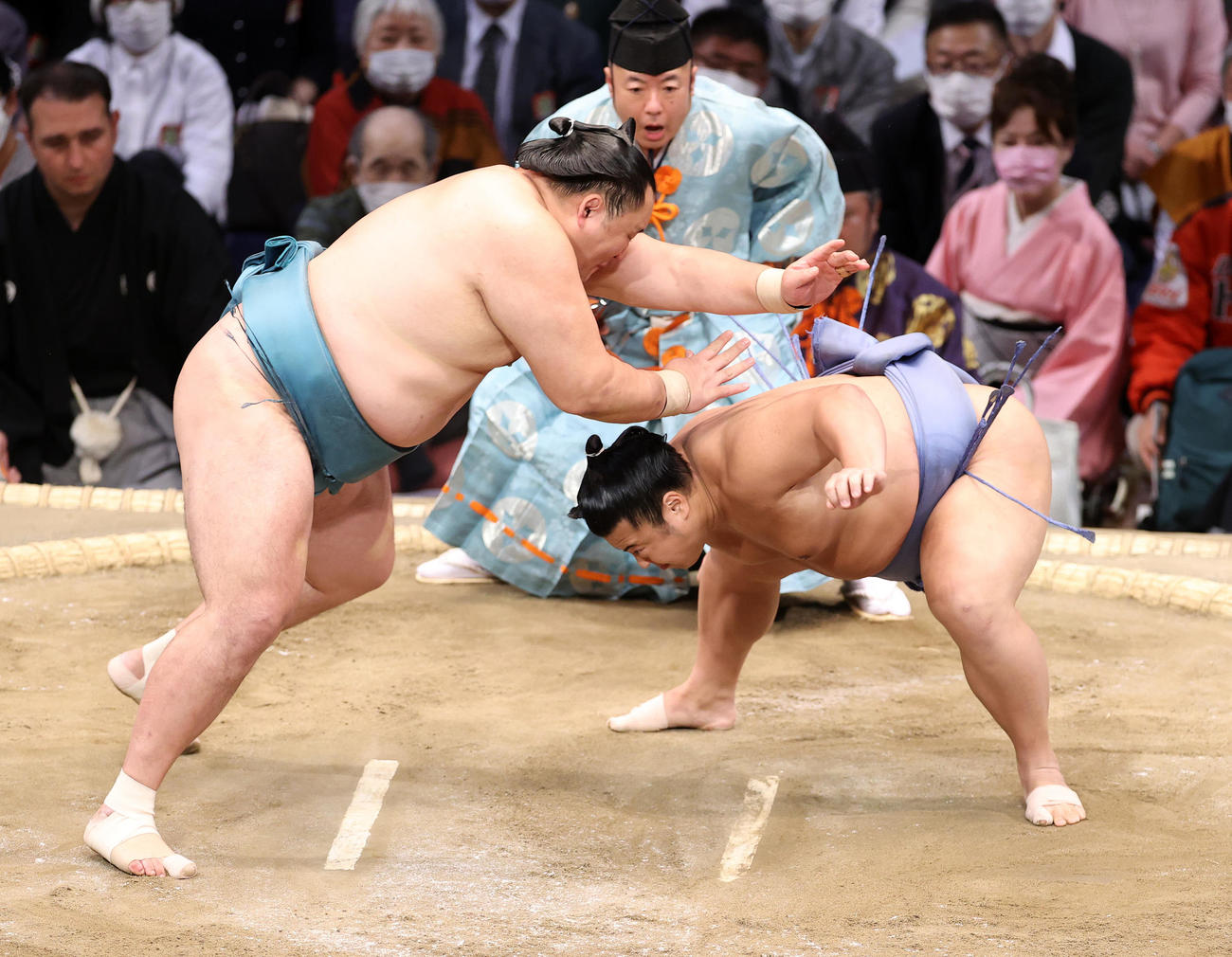 立ち合いで玉鷲（左）の足下を狙う翔猿（撮影・鈴木正人）