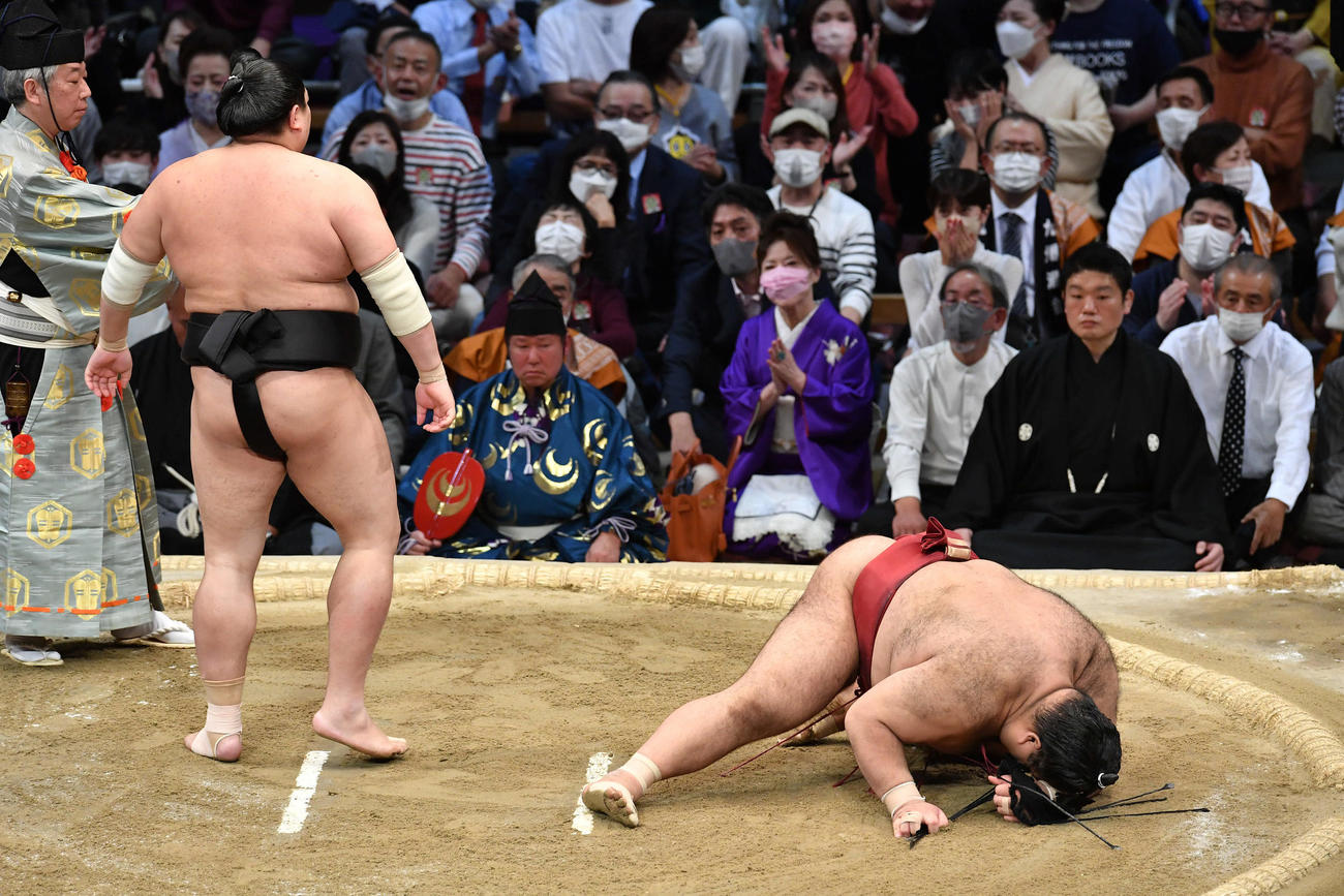 ともえ戦で、阿炎（左）にはたき込みで敗れた高安はその場にうずくまる（撮影・岩下翔太）