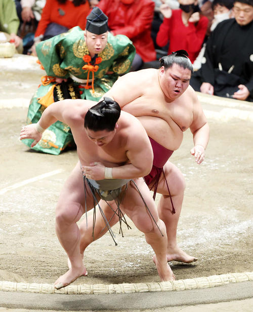 若隆景(手前)を送り出しで破る御嶽海(撮影・鈴木正人)