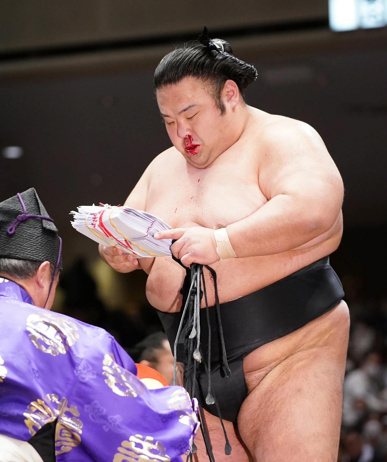 鼻血を流しながら懸賞金を手にする貴景勝（撮影・小沢裕）