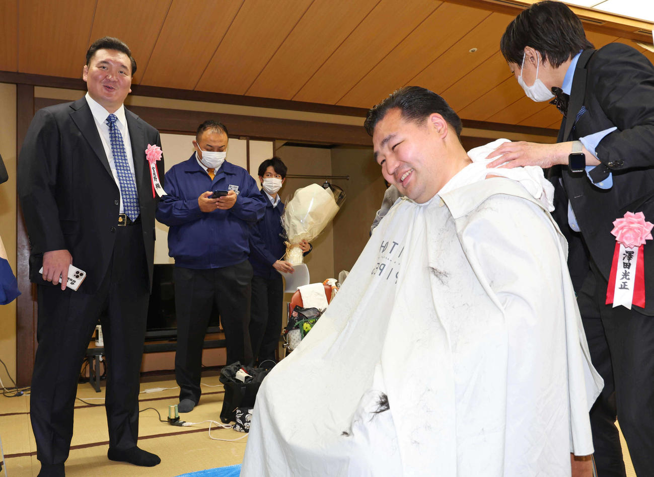 宮城野親方（左）に見守られながら笑顔で整髪する鶴竜（代表撮影）
