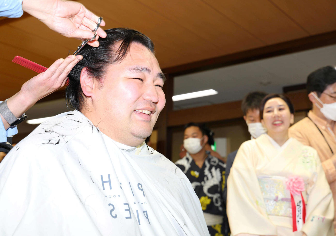ダシニャム・ムンフザヤ夫人（右）に見守られながら整髪する鶴竜（代表撮影）