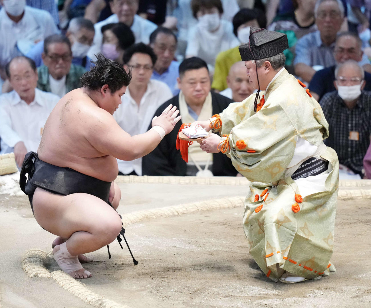 手刀を切り懸賞金を受け取る伯桜鵬（撮影・小沢裕）