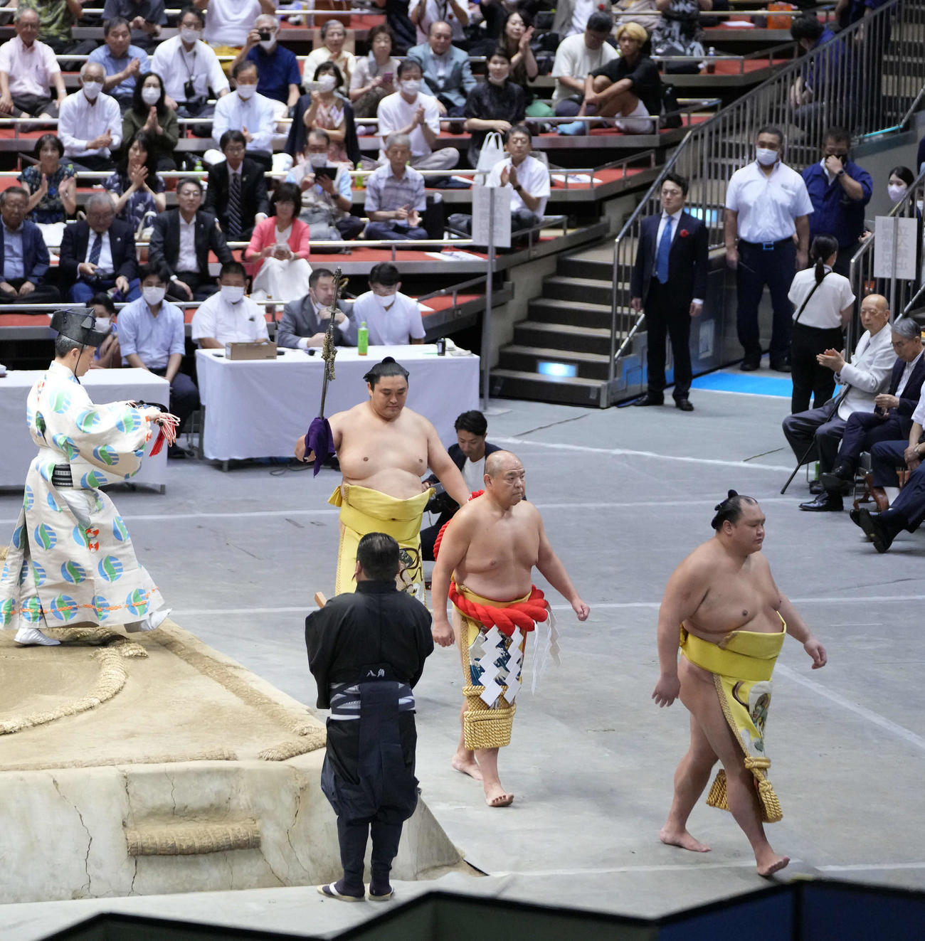 還暦土俵入りを終え引き揚げる八角理事長。（右）。手前右は露払いの北勝富士、1人おいて太刀持ちの君ヶ浜親方（元関脇隠岐の海）（撮影・小沢裕）