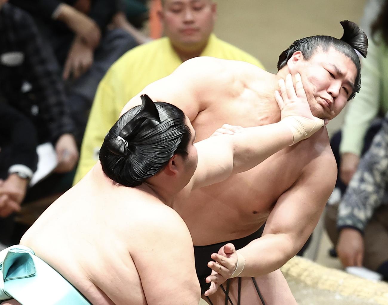 琴ノ若（手前）ののど輪に耐える若元春（撮影・河田真司）