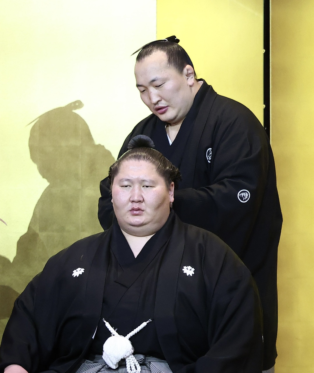 千代翔馬（後方）にはさみを入れてもらう逸ノ城（撮影・河田真司）
