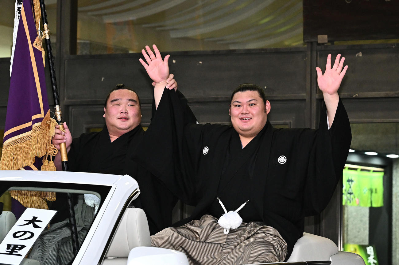 優勝パレードで手を振る大の里（右）と旗手の白熊（撮影・滝沢徹郎）