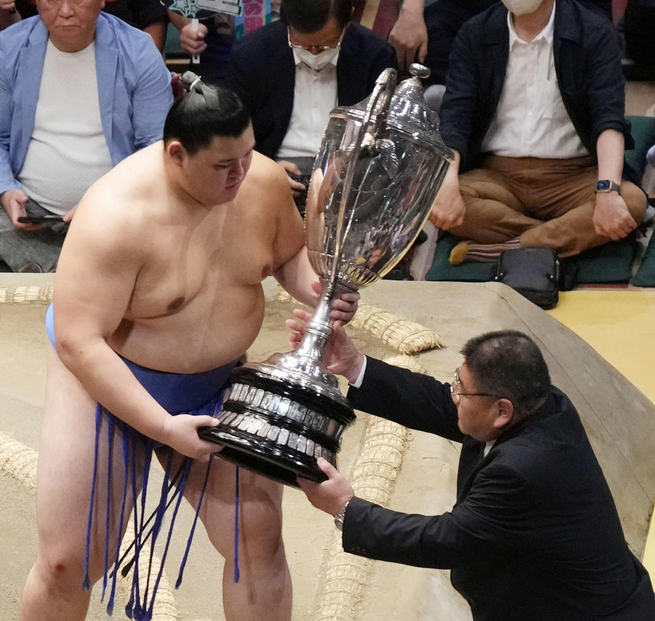 表彰式で大の里（左）から優勝賜杯を預かる若者頭の花ノ国（撮影・小沢裕）