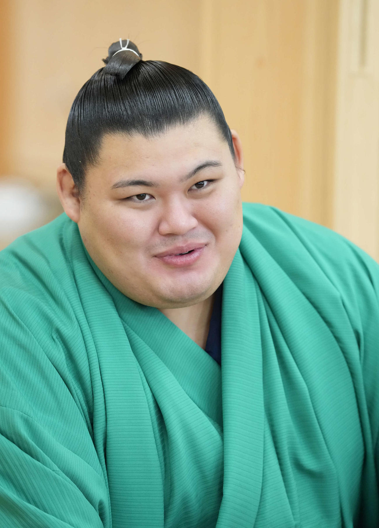 大相撲秋場所の優勝一夜明け会見で笑顔を見せる大の里（撮影・小沢裕）
