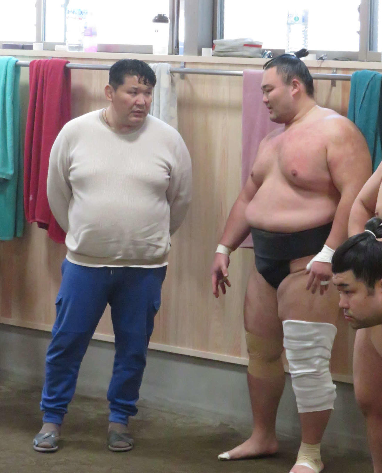 大けがした左膝に大きなサポーターを施して再開した相撲を取る稽古後、朝乃山（右）は師匠の高砂親方と話し込んだ
