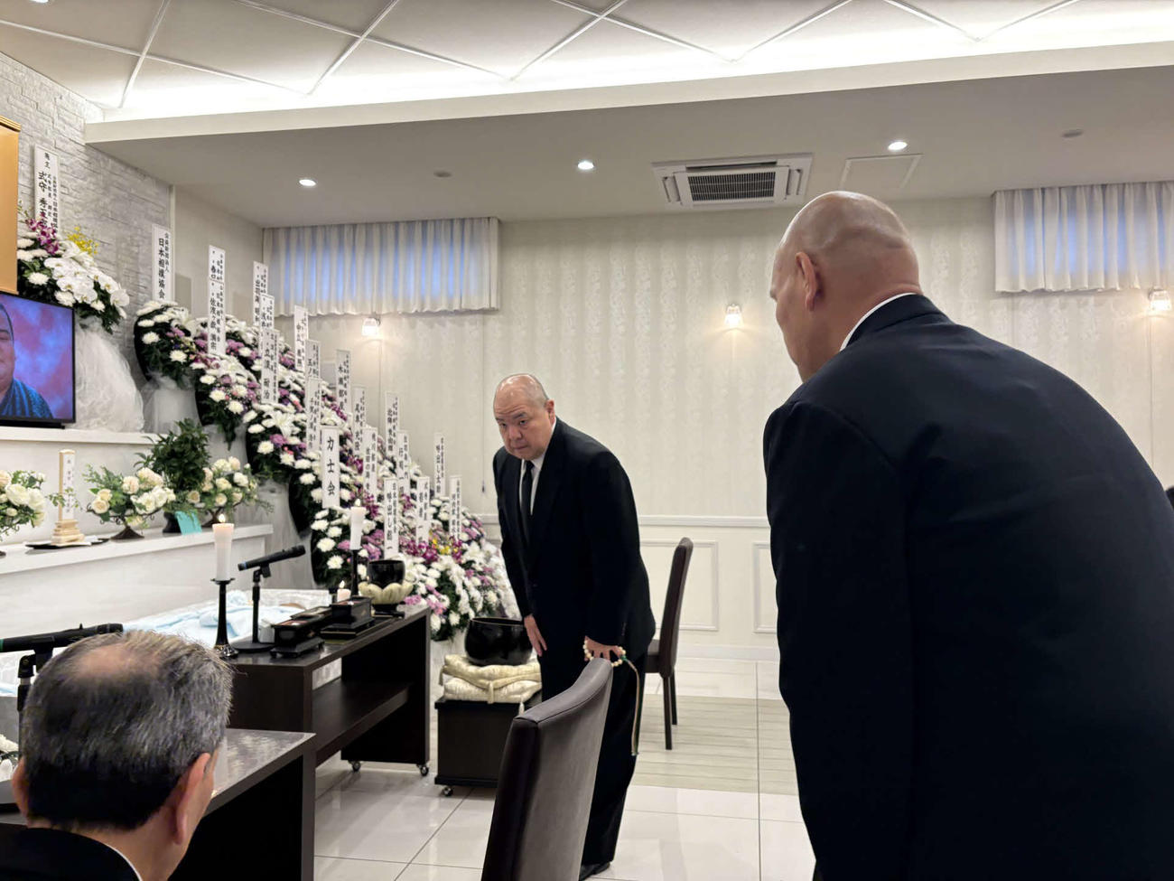 2025年4月22日、若戸桜さんの通夜に参列し、関係者に挨拶する八角理事長（中央）