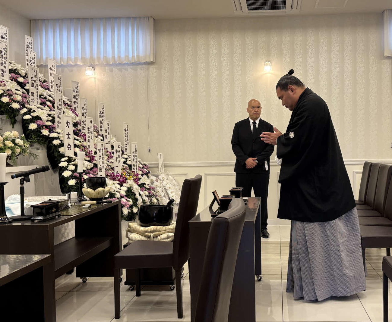 2025年4月22日、若戸桜さんの通夜に訪れた豊昇龍（手前）。奥は式秀親方（元幕内北桜）