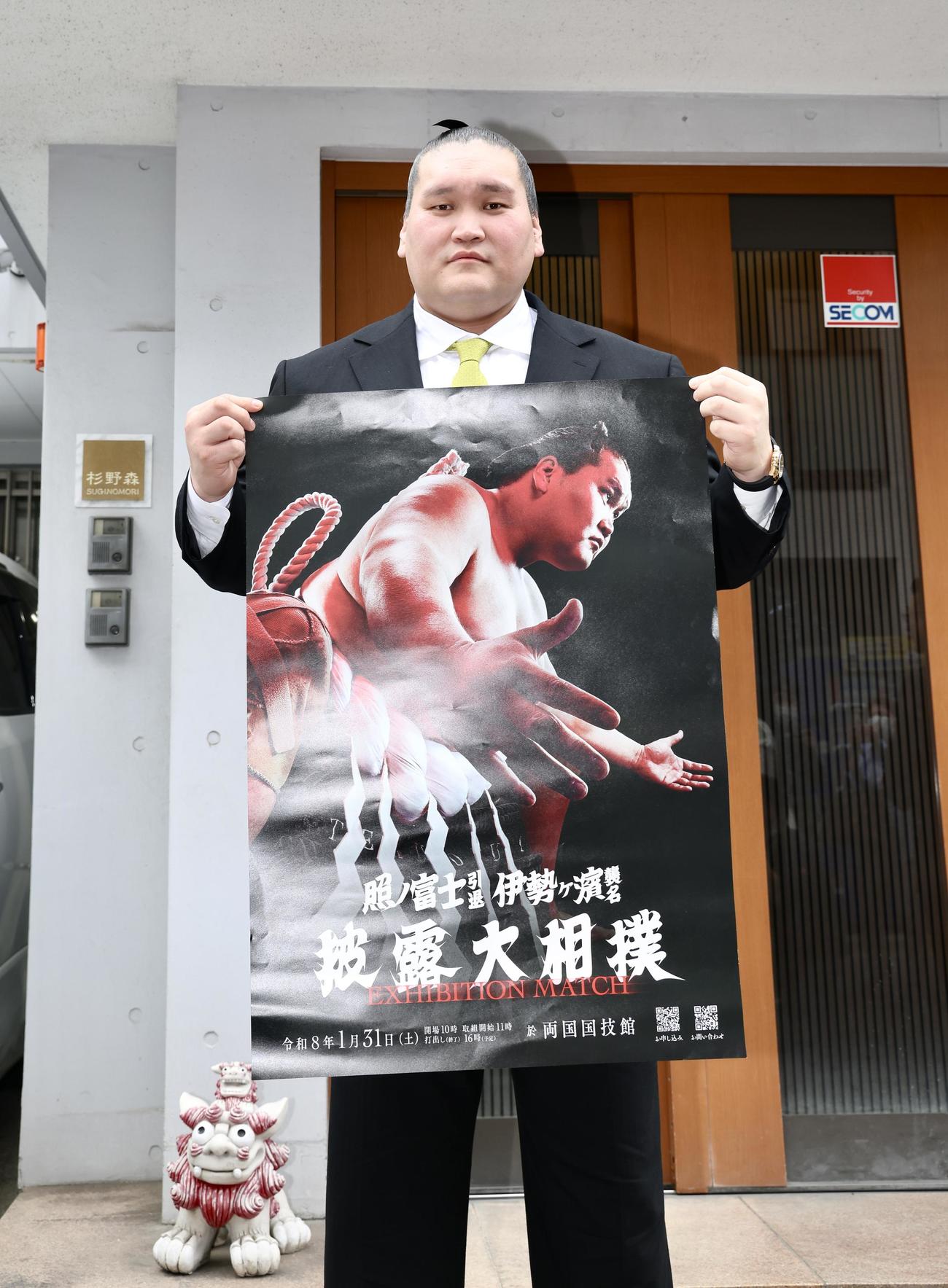 引退相撲のポスターを手に写真に納まる伊勢ケ浜親方（撮影・河田真司）
