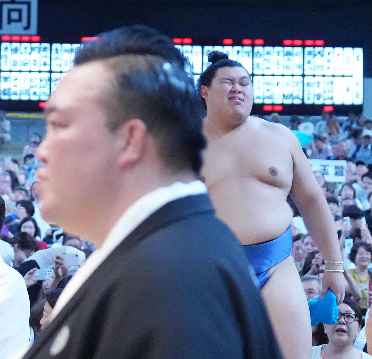 3敗目を喫した大の里は悔しそうな表情で花道を引き揚げる。手前左は審判を務めた師匠の二所ノ関親方（撮影・小沢裕）
