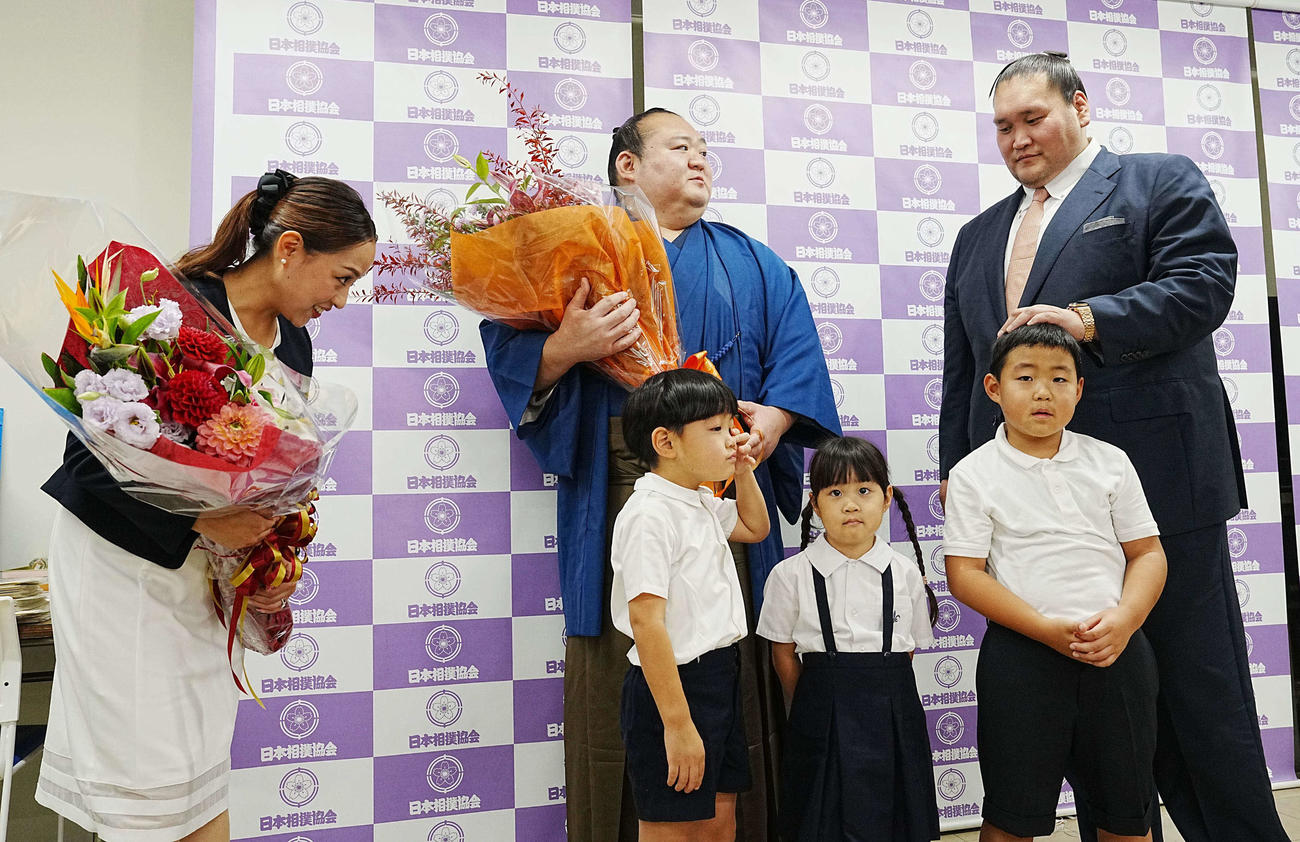 引退会見を終え家族と記念撮影に臨む宝富士。前列左から次男凜丞（りんのすけ）くん、長女七凪（なな）ちゃん、長男慶丞（けいのすけ）くん、後列左から英莉乃夫人、1人おいて師匠の伊勢ケ浜親方（撮影・小沢裕）
