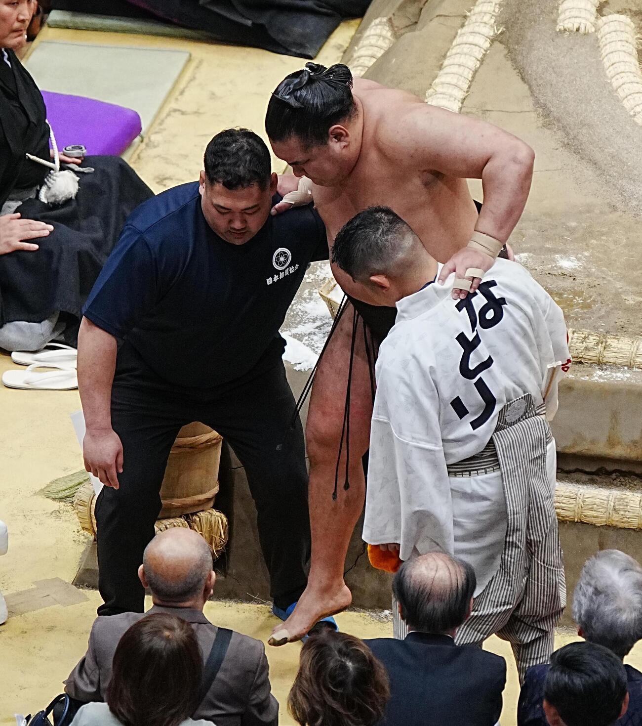 右太ももを痛めたと思われる豊昇龍は呼び出しらの肩を借りて土俵を下りる（撮影・小沢裕）