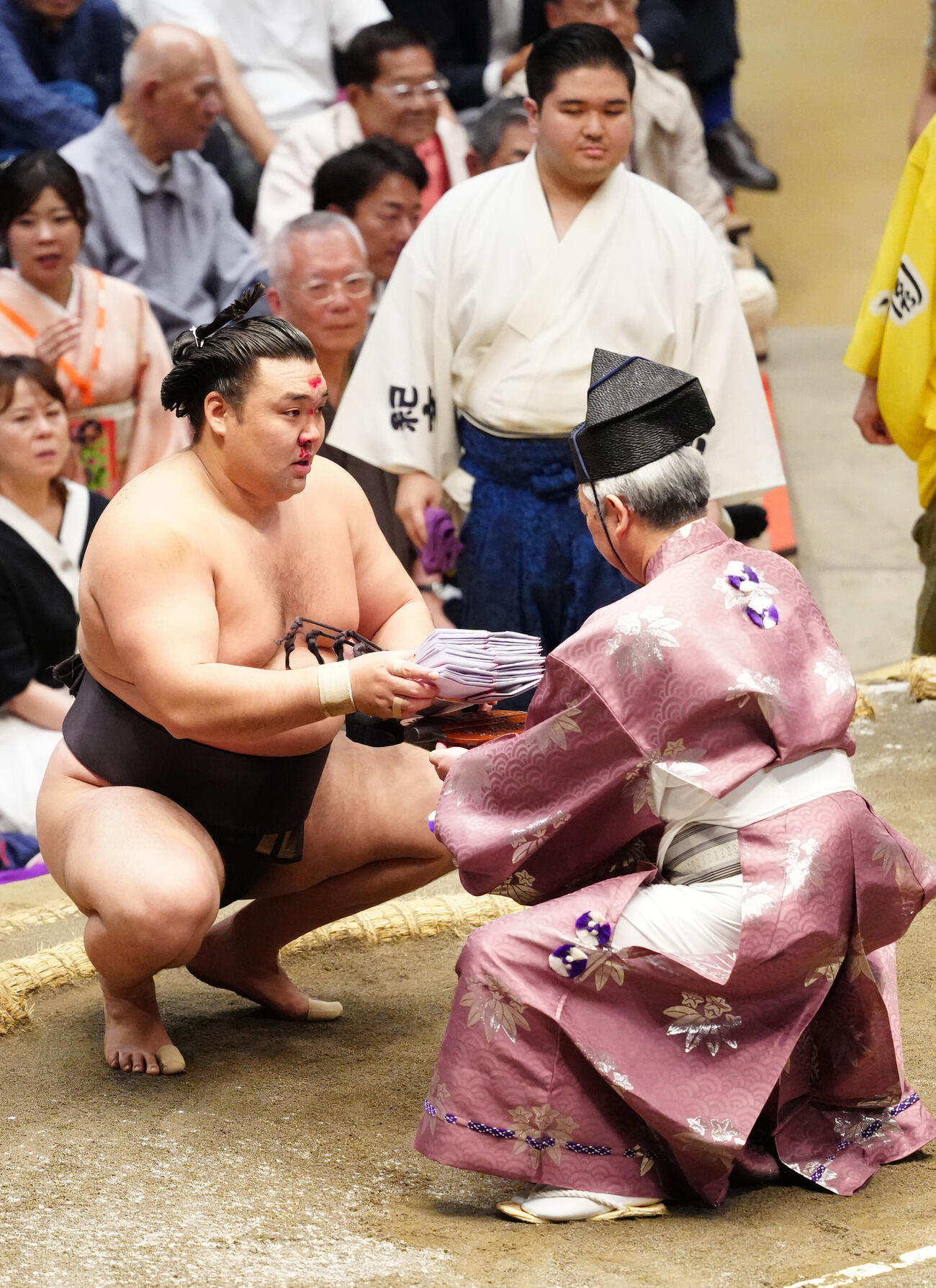 大相撲夏場所9日目　若元春を寄り倒しで破り、懸賞を受け取る霧島（撮影・江口和貴）