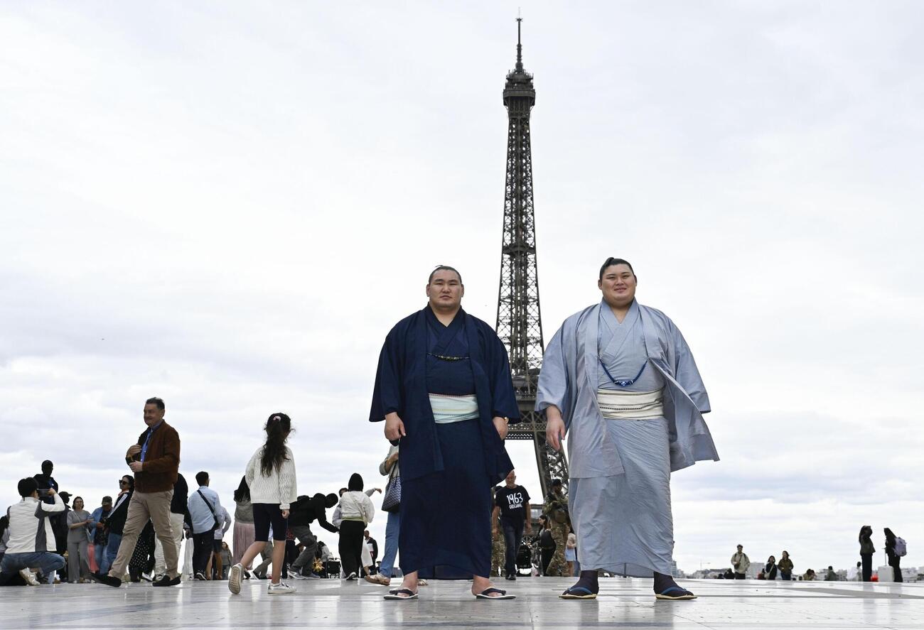 大相撲パリ公演を前に、エッフェル塔の前で写真に納まる大の里（右）と豊昇龍の両横綱（共同）