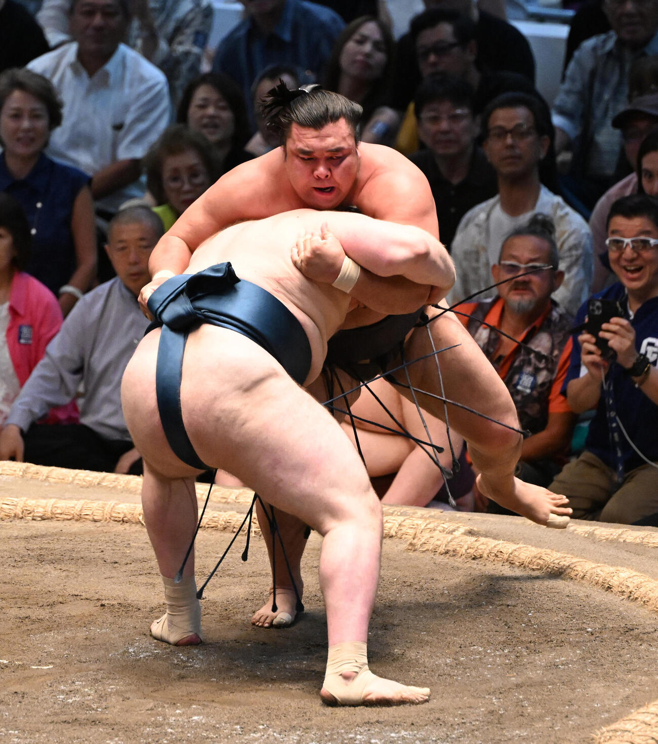 安青錦（手前）は霧島を寄り切りで破る（撮影・和賀正仁）
