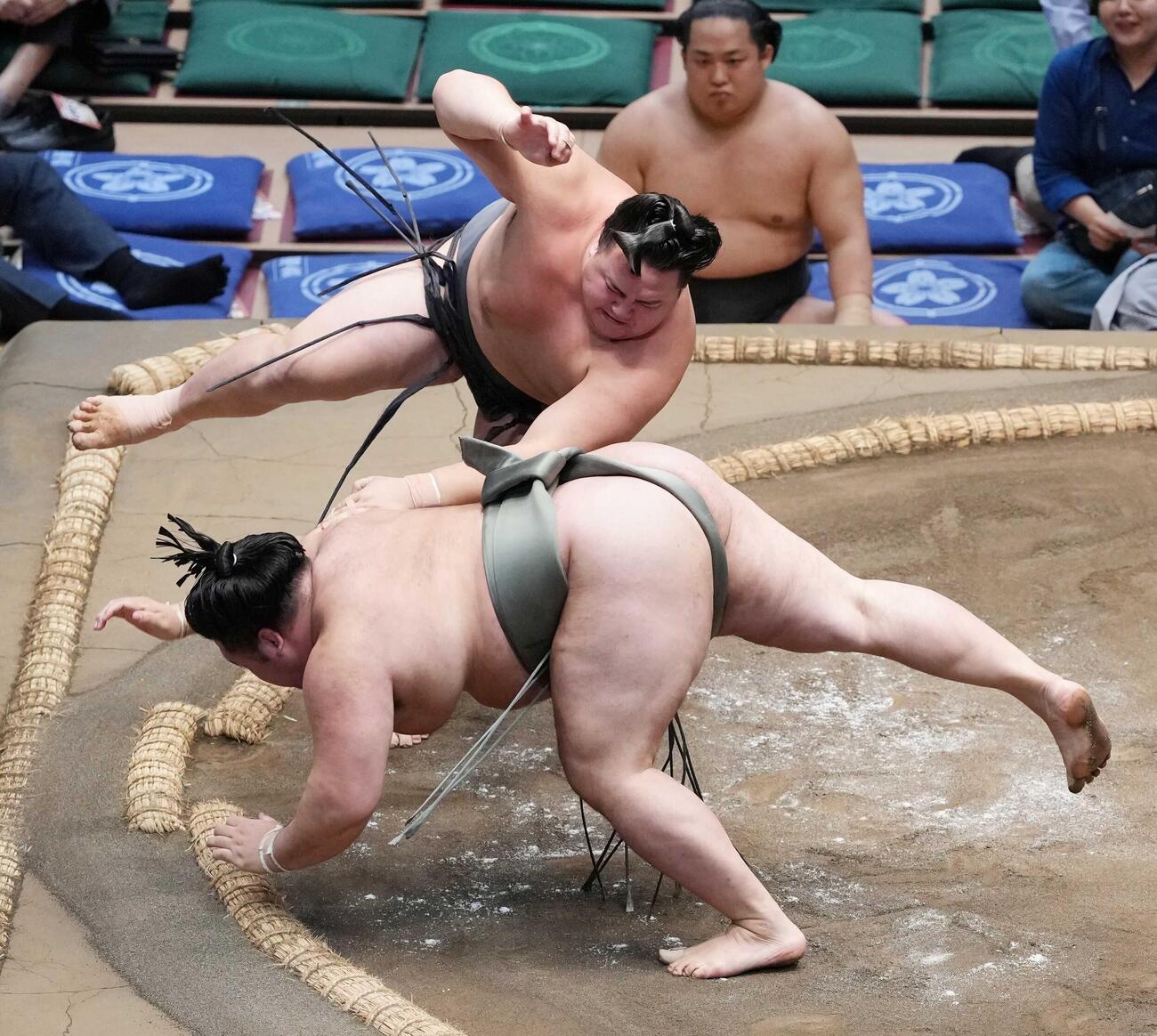 丹治は明生（手前）を突き落としで下す（撮影・小沢裕）