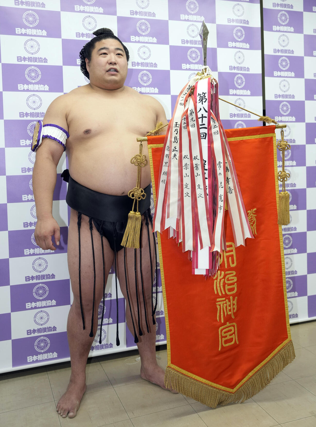 優勝した若元春は優勝旗を手に写真に納まる（撮影・小島史椰）