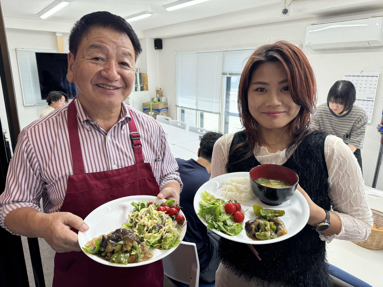 ランチを盛り付けした北川拓社長（左）と勤続９年の玉島杏柚さん