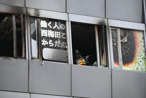 ビル火災があった現場を調べる消防士（撮影・松浦隆司）