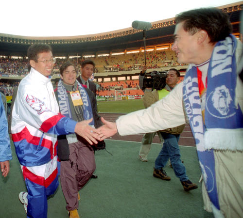 ジョン・カビラと弟の慈英が岡田監督に握手を求める日刊スポーツ1面を飾った写真（97年撮影）