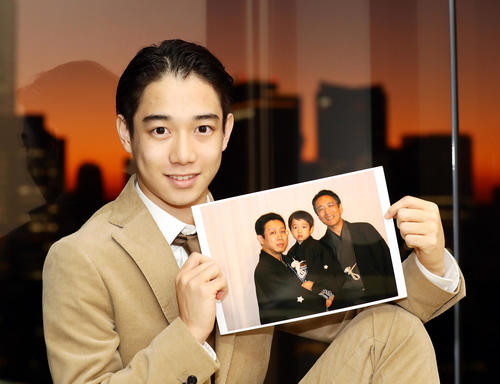 来年で20歳を迎える片岡千之助は、初舞台前の祖父・片岡仁左衛門と父・片岡孝太郎との写真を手に柔らかい表情を見せる（撮影・浅見桂子）