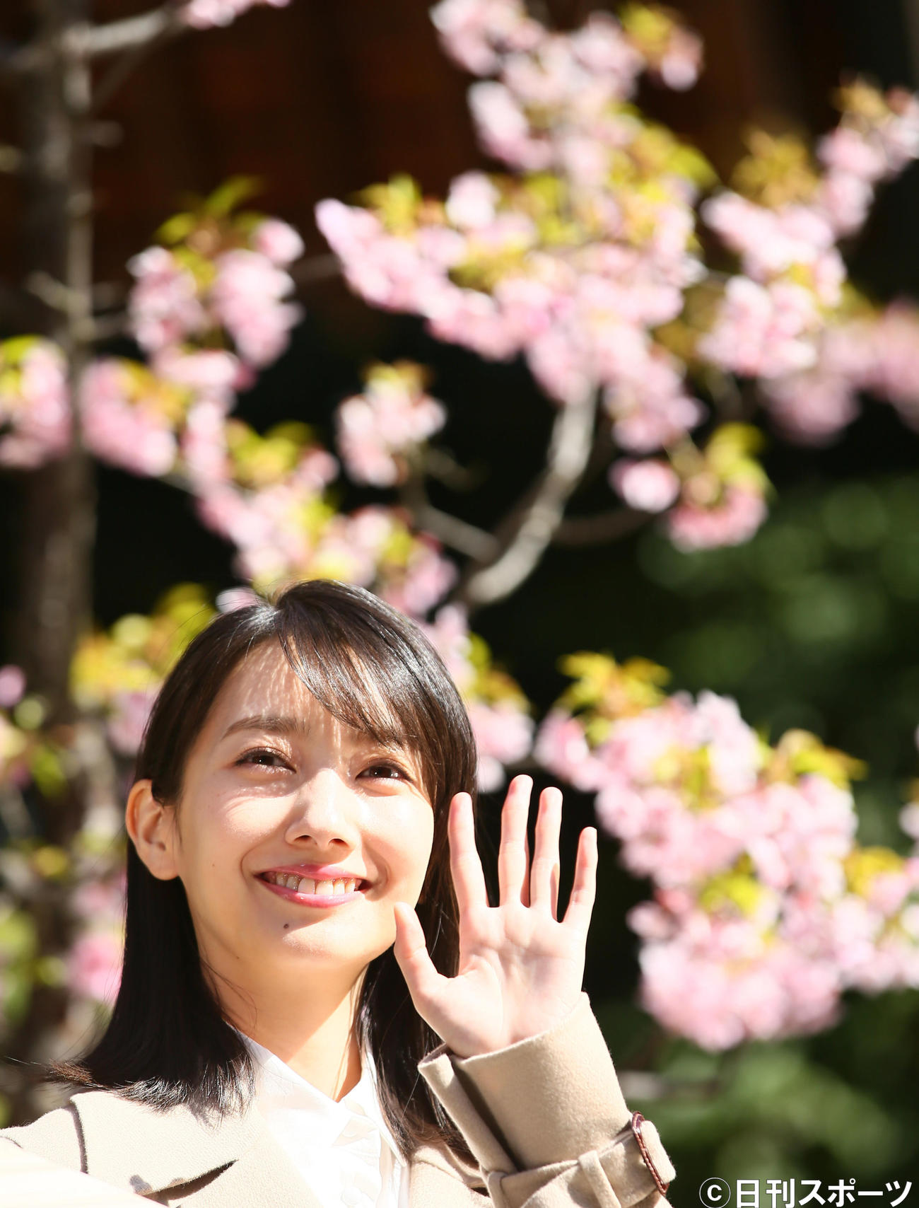 早咲きの桜を背に笑顔を見せる波瑠（撮影・足立雅史）
