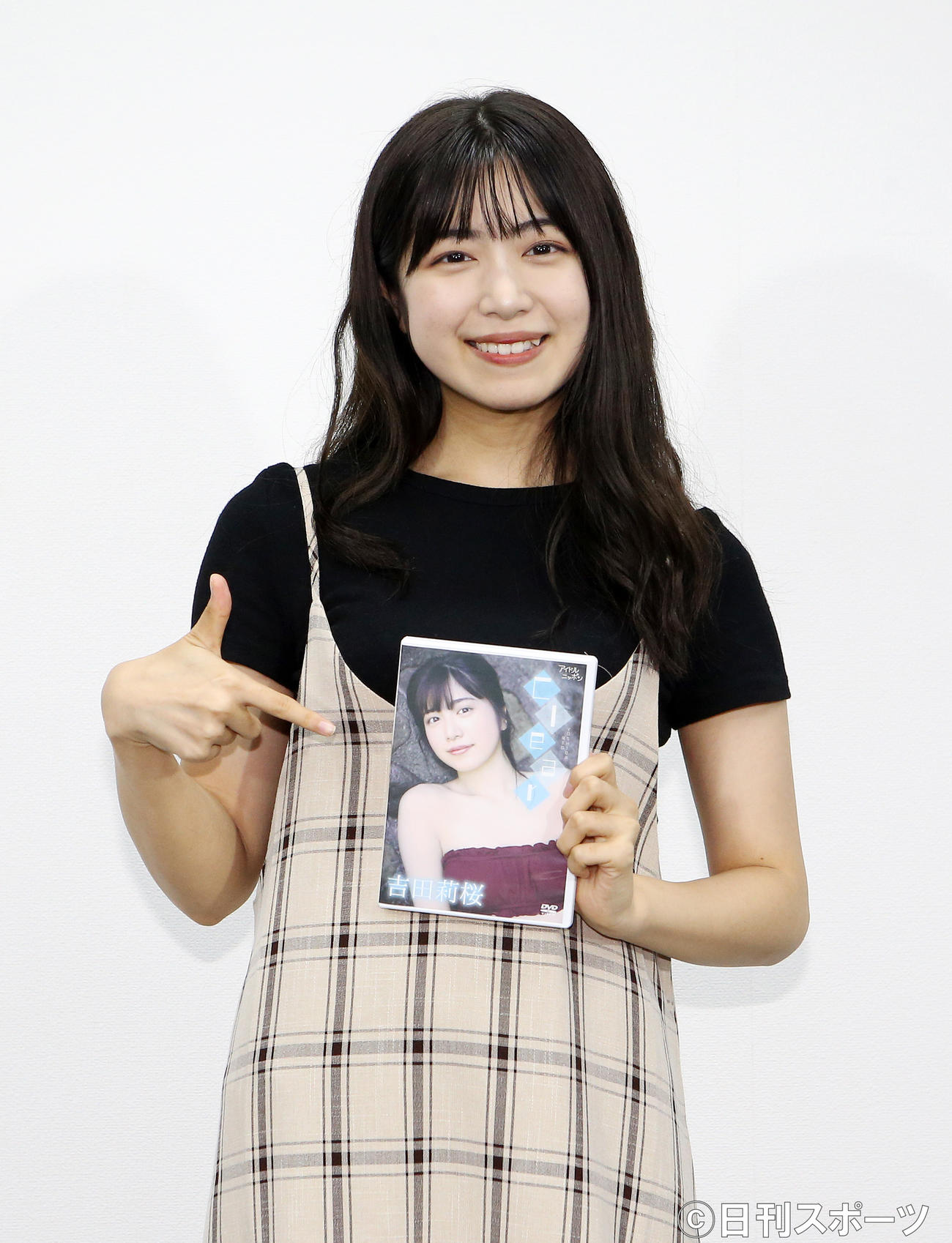 1stDVDを片手にポーズを決める吉田莉桜（撮影・阿部泰斉）