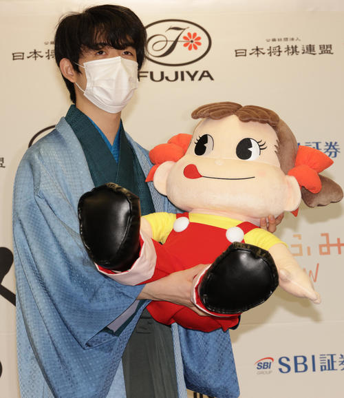 史上初の10代3冠を達成し、記念のマスコット「ペコちゃん」を贈られた藤井聡太新叡王(撮影・中島郁夫)