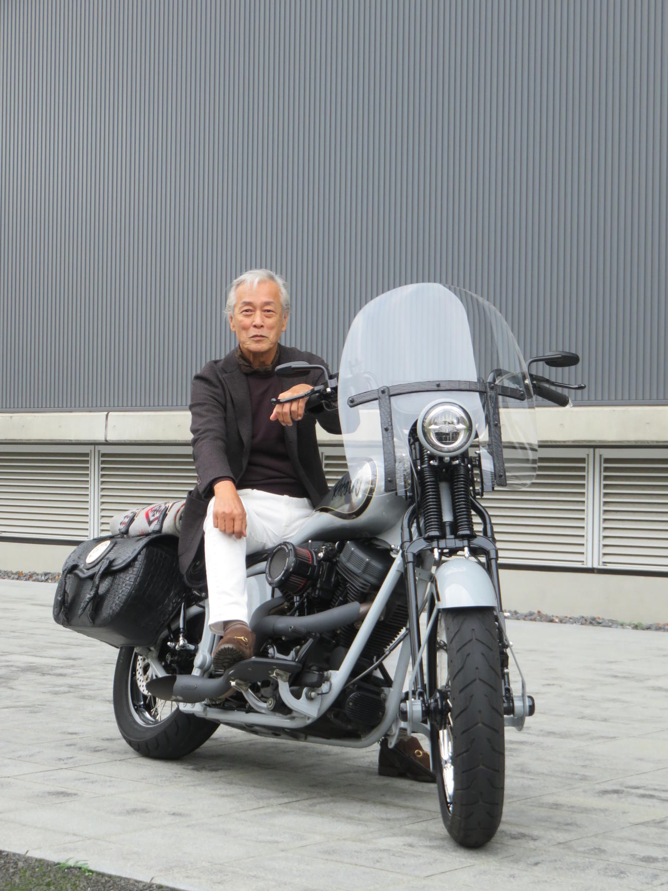 北海道まで1500キロメートルを走破したハーレーに股がってポーズを取る岩城滉一