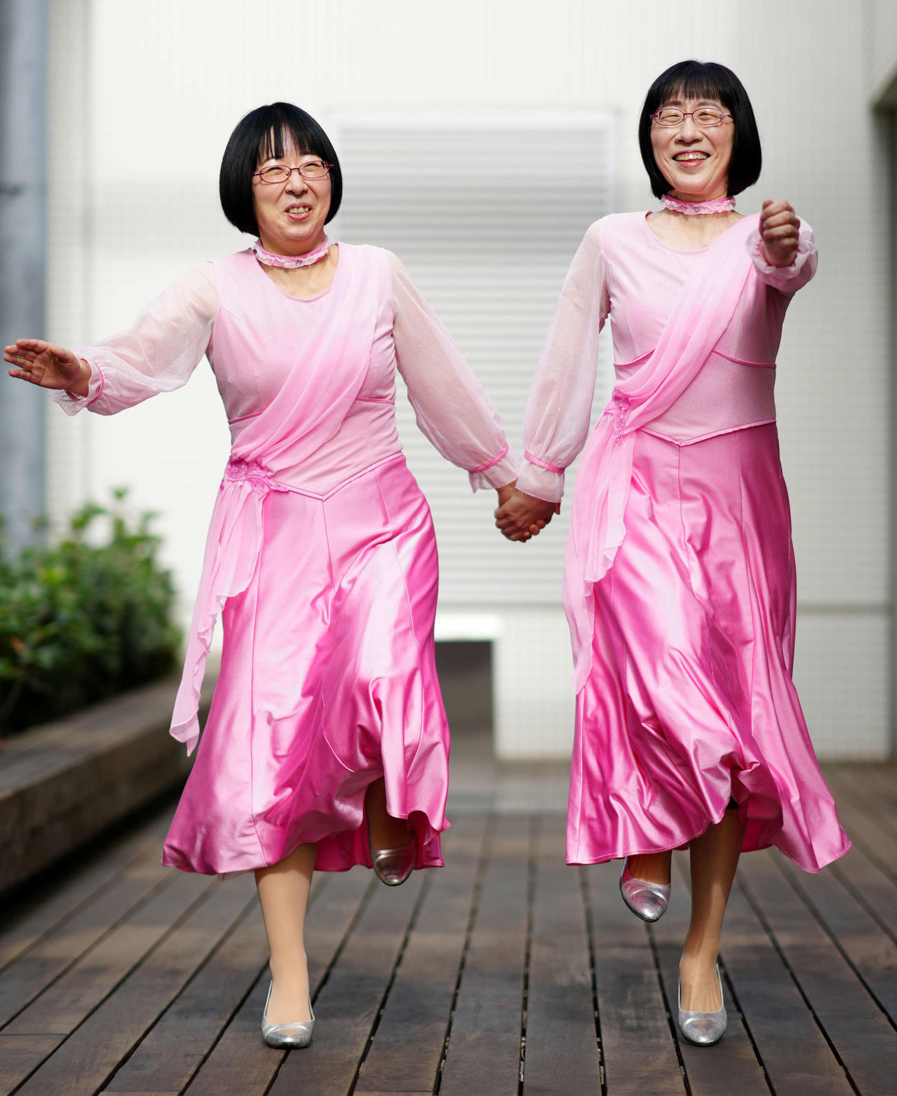 手をつなぎスキップするお笑いコンビの「阿佐ヶ谷姉妹」。右は姉の渡辺江里子、左は妹の木村美穂（撮影・江口和貴）