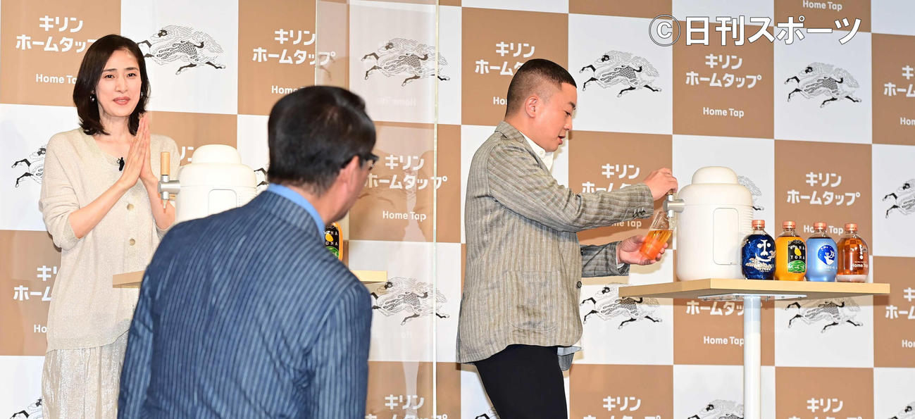 会員制生ビールサービス「キリンホームタップ」3社合同新ビールラインアップ発表会でグラスにビールを注ぐチョコレートプラネット松尾駿（右）の様子を舞台を降りてチェックする中井貴一（手前）。左は天海祐希（撮影・小沢裕）