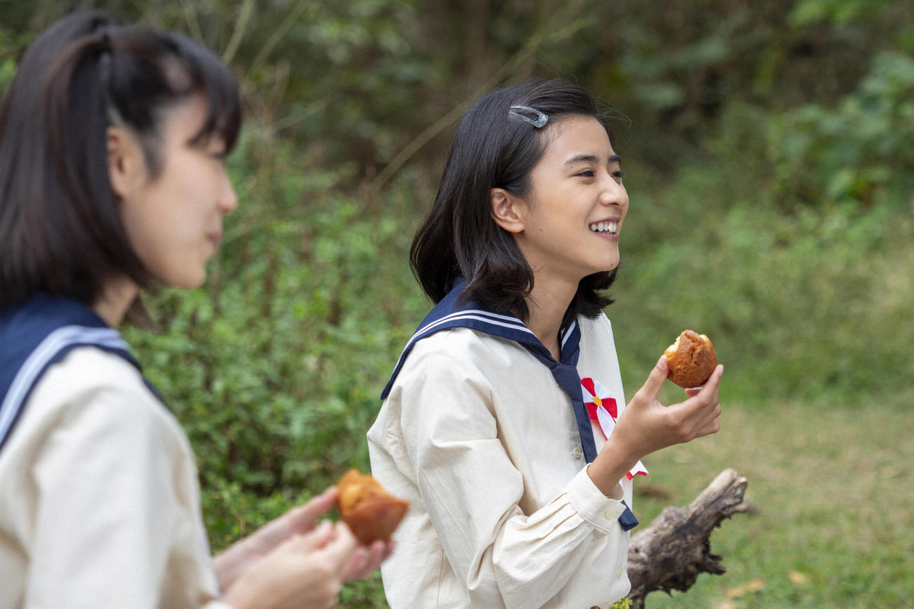 朝ドラ「ちむどんどん」より。サーターアンダギーを手に笑顔の比嘉暢子（黒島結菜）（C）NHK