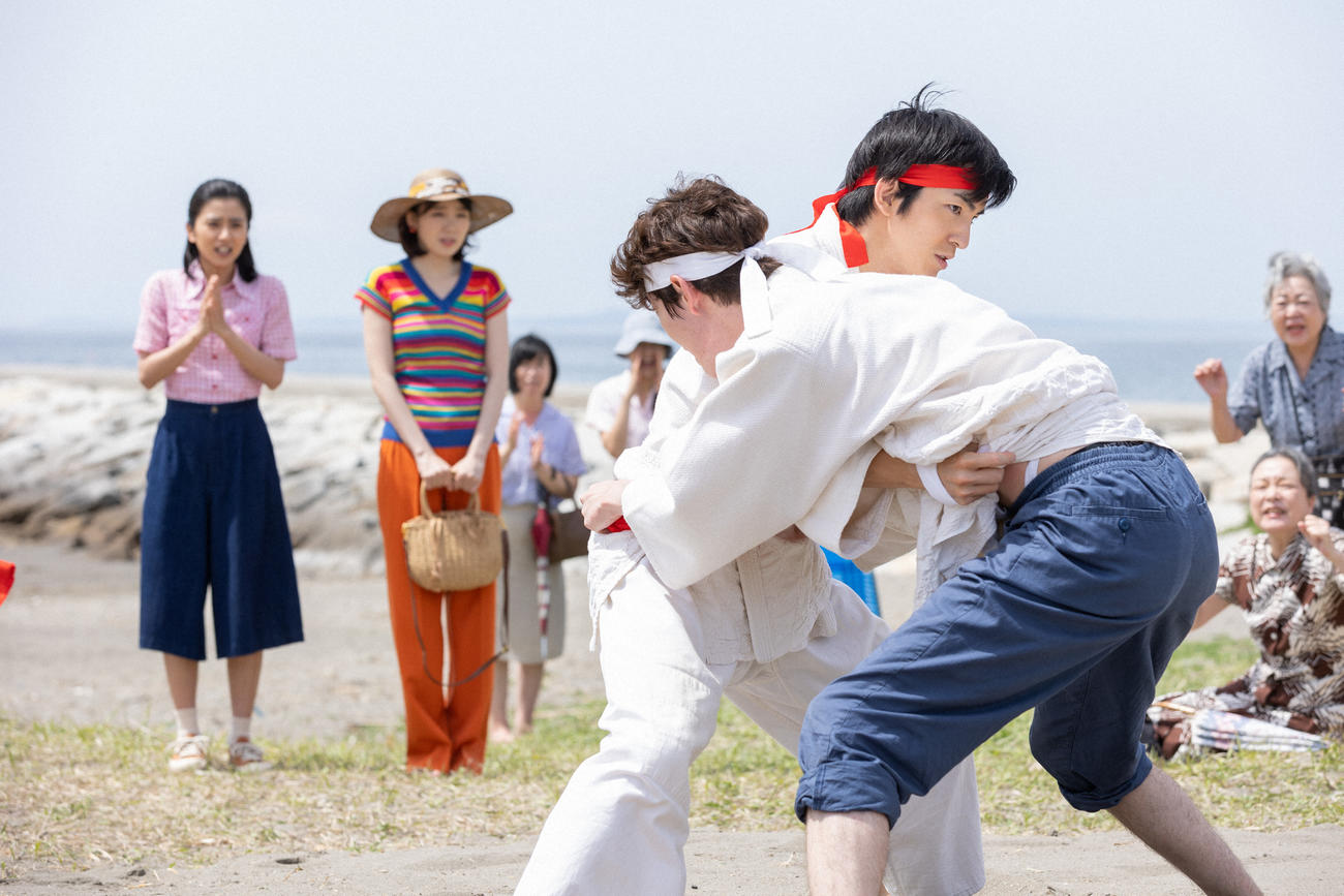 朝ドラ「ちむどんどん」より。沖縄県人会の遠足の余興「沖縄角力大会」で組み合う砂川智（手前左＝前田公輝）と青柳和彦（同右＝宮沢氷魚）(C)NHK
