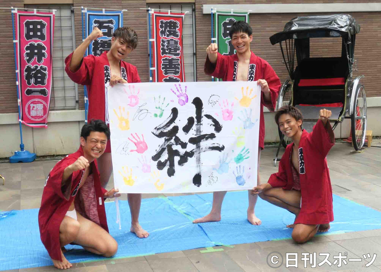 新曲「Sole!～おまんた囃子～」発売記念イベントで自作の旗を披露する東京力車のメンバーたち