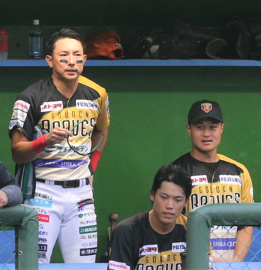 栃木対茨城　チームメートの川崎宗則（左）の横で試合を見つめる栃木・ティモンディの高岸宏行（撮影・藤塚大輔）