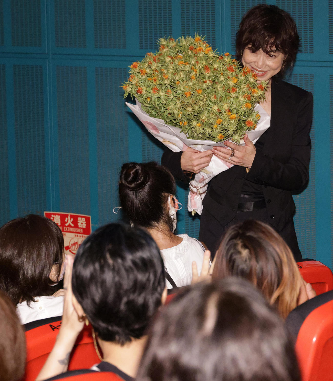 紅花の花束を抱え映画「紅花の守人」初日舞台あいさつを行った今井美樹（撮影・中島郁夫）